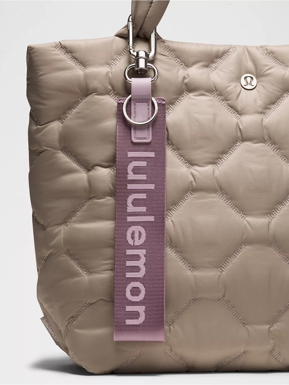 LULULEMON  “NEVER LOST” key chain. Color: Lotus Lavender/Lilac Play/Silver.
